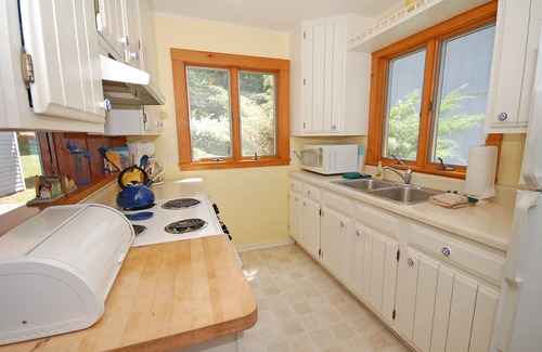 Glen Arbor House | Lakefront cottage with a deck, grill, firepit, dock & partial AC