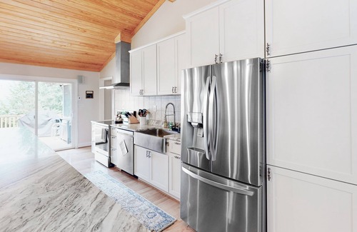 Mineral House | Lakefront home with granite counters, fireplace, lake views, & dock