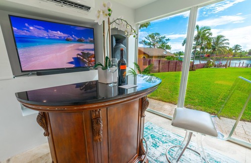 Lake Worth House | Lakefront Oasis 6BD, Sleep 14, Heated Pool, Tikis, Golf, Dock on Lake, No Stairs