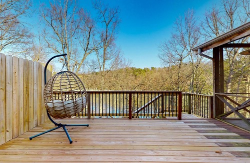 Powell House | Lakefront retreat with screened sunroom, wood stove, multiple decks, & AC