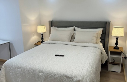 Ottawa Division House | Large bedroom with private bathroom and workspace.