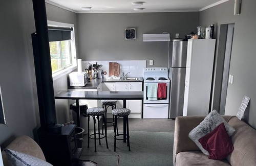 Mokihinui House | Large home with stunning sunset views.