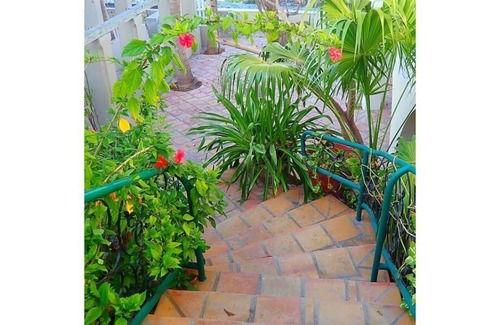 Cockburn Town House | Lazy lobster - Grand Turk B&B - Cozy balcony room with 2 queens beds