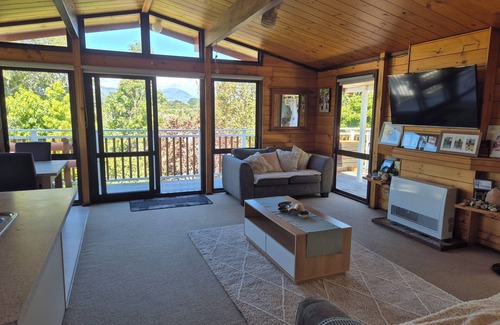 New Plymouth House | Lockwood holiday house, nestled among lush trees.