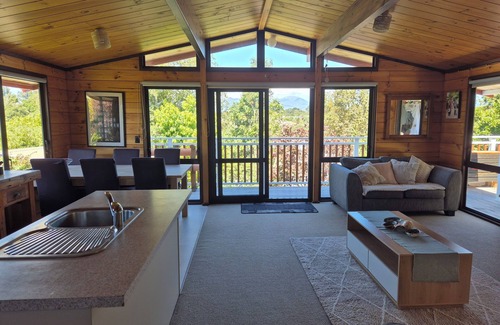 New Plymouth House | Lockwood holiday house, nestled among lush trees.