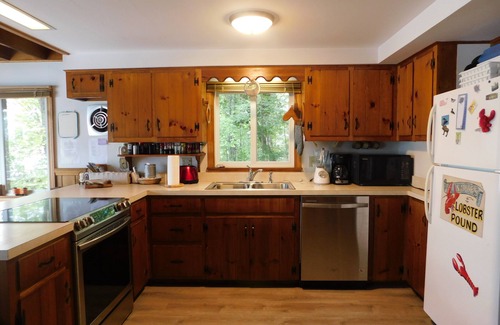 Naples Ski Chalet | Long Lake chalet and guest house with 200' of water frontage and sunset views