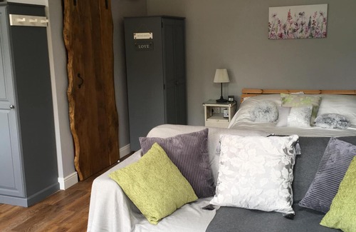Sandy Lane Cabin | Lovely Wooden Lodge, views over an orchard, outside seating.