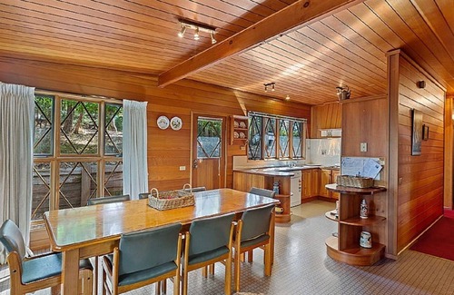 Sawmill Settlement Cabin | Lumi Talo - Retro quintessential two-story cedar lodge