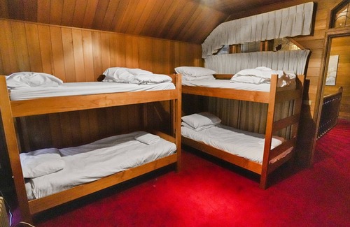 Sawmill Settlement Cabin | Lumi Talo - Retro quintessential two-story cedar lodge
