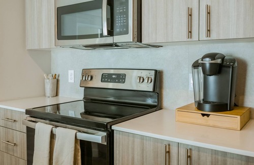 Miami Gardens Condo | Luxe, dog-friendly condo with resort-style pool, playground, gym, patio, & lake