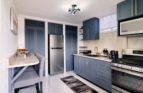 Kingstown Apartment | Luxurious 1 bedroom haven, modern kitchen moments from pristine black sand beach