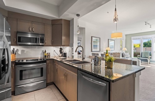 Vernon Condo | Luxurious Lakeside Living at The Strand! Pool, Hot Tub & Beach Access!