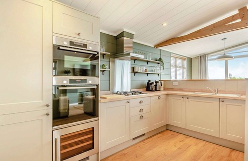 Middlezoy Ski Chalet | Luxurious lodge with vaulted ceilings and a welcoming feature fireplace.