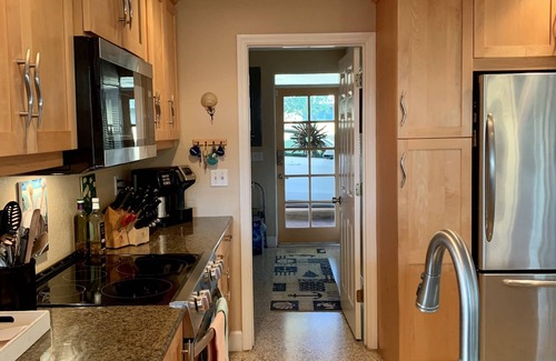 Whitney Beach House | Luxurious waterfront home with pool & spa…serene beach 5 min stroll away.