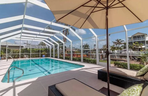 Isles of Capri House | Luxurious Waterfront Retreat! Oversized Heated Pool and expansive outdoor area!