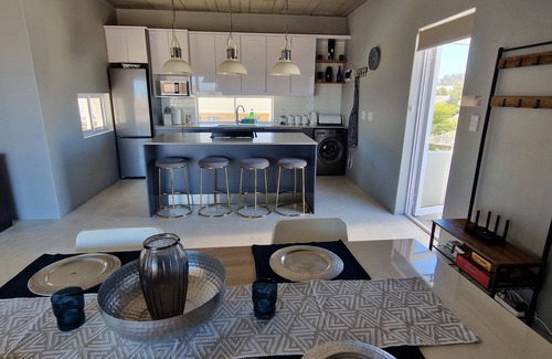 Sandbaai House | Luxury 2 Bed apartment boasting a rooftop terrace, with mountain & sea views.