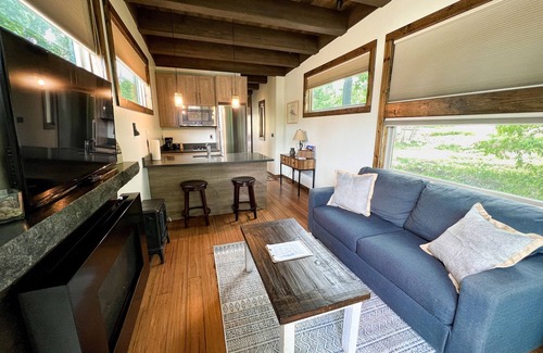 Montrose House | Luxury Accommodation. Bedroom with queen bed. Sleeper sofa in living area. Full bath with shower. Kitchen. Living area with TV and Fireplace. Washer/Dryer.