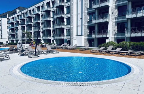 Dzielnica Uzdrowiskowa Apartment | Luxury apartment with private 17sq terrace swimming pools saunas gym playground
