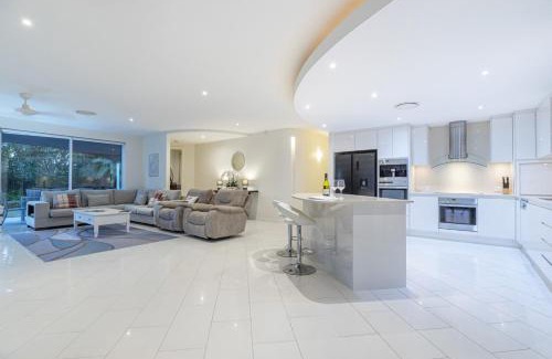 Pelican Waters House | Luxury resort style villa pool by Custom Bnb Hosting