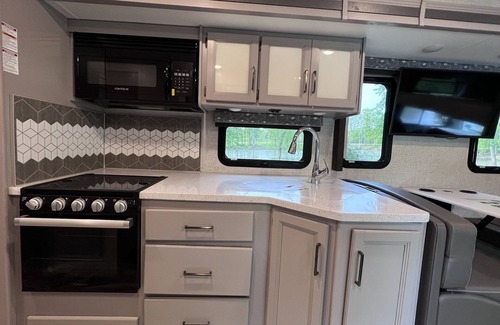 Walker House | Luxury RV with Bunkbeds Stationed near a Serene River