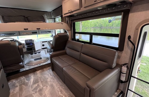 Walker House | Luxury RV with Bunkbeds Stationed near a Serene River