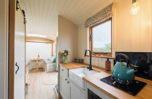 Menai Bridge Apartment | Luxury Shepherds Hut with hot tub, firepit and gas barbeque