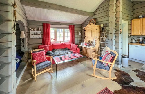 Nord-Torpa House | Make yourself comfortable in this open-plan log cabin with a wonderful view of the countryside.