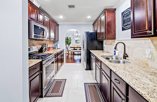 Spring Branch West House | Mapleton Place | House in Houston with fireplace, patio, & W/D