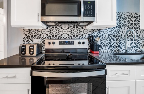 Historic Downtown Savannah Apartment | Mid-Century Cool + Private Parking for 2 Cars on Liberty by Lucky Savannah