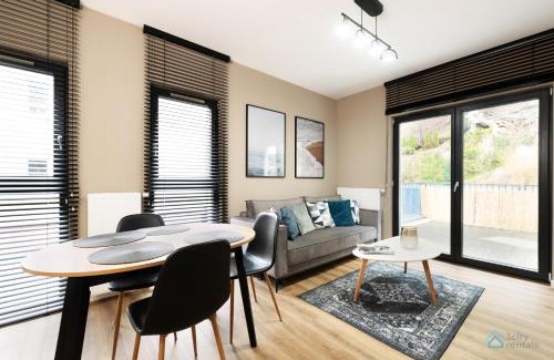 Dziaki Lesne Apartment | Modern Beige and Grey 3city Apartment in Gdynia by Noclegi Renters