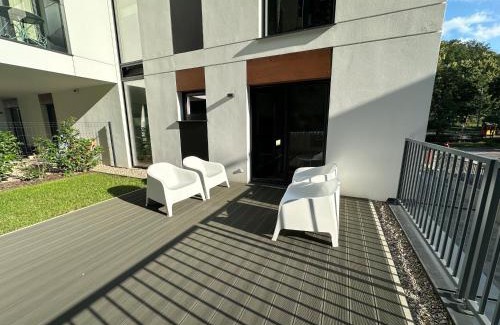 Dziaki Lesne Apartment | Modern Beige and Grey 3city Apartment in Gdynia by Noclegi Renters