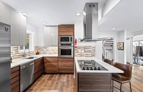 Bushkill House | Modern Creek-front House with Volleyball court in the backyard.