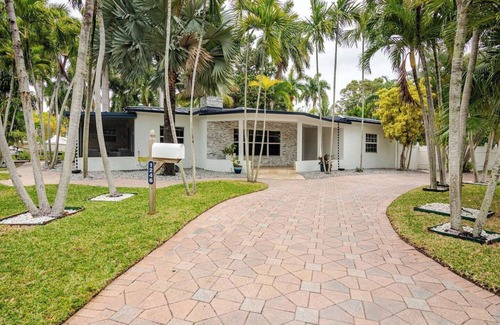 South Lake Villa | Modern Hollywood Beach villa with a private heated saltwater pool, hot tub, and spacious family-friendly layout. Just 1 mile from the ocean & Broadwalk, featuring a full kitchen, open living areas, and tropical outdoor lounge spaces.