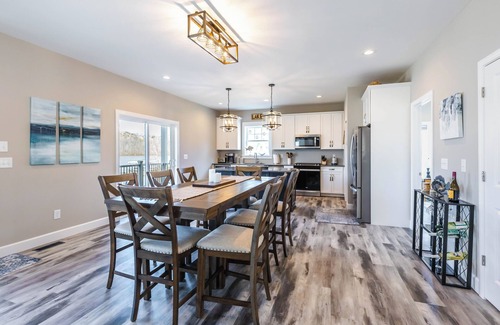 Ingles House | Modern lakefront home with wraparound decks, firepit, and stunning water views on both levels.
