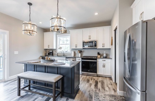 Ingles House | Modern lakefront home with wraparound decks, firepit, and stunning water views on both levels.