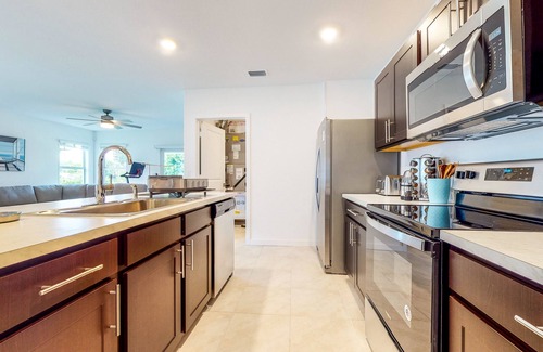 Stuart House | Modern Treasure Coast home with Peloton, EV charger, tennis, patio, & central AC