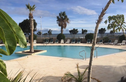 El Medano Apartment | Modern two floor apartment right by the beach with pool, patio and paddle court