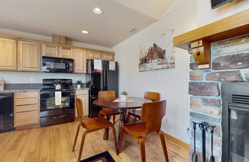 Ronald Condo | Mountain view condo with balcony, fireplace, pool, hot tub, gym & tennis