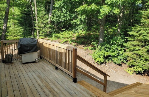 Wymbolwood Beach Cottage | Near Sandy Beach, Comfy Cottage - Multi leveled Deck with Woodland Backdrop