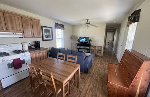 Gallatin Cabin | Nestled in nature, the cabin resides near a tranquil pond, perfect for fishing