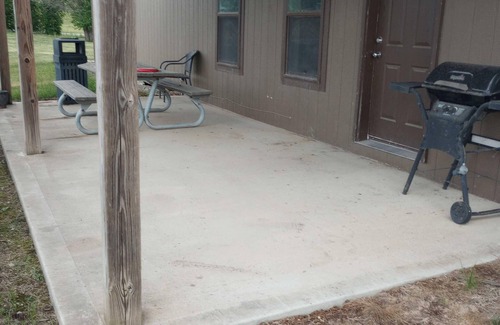 Gallatin Cabin | Nestled in nature, the cabin resides near a tranquil pond, perfect for fishing