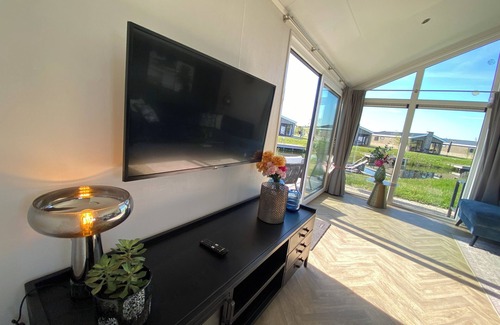 Municipality of Kampen House | NEW Elegant waterfront chalet with jetty Lake Kampen Netherlands vacation home boat