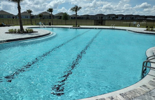 Haines City House | New House 25 Minutes from Disney World with King size bed and Community Pool.