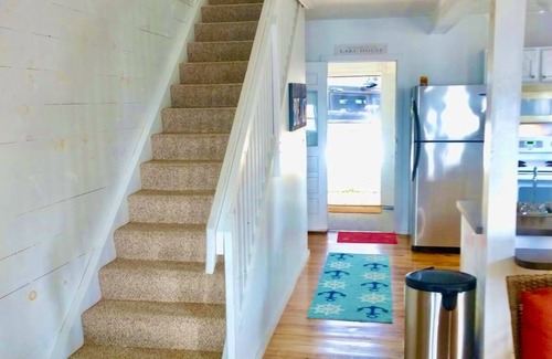 Prudenville House | New Listing! Lake front cottage with 100' of private sandy beach