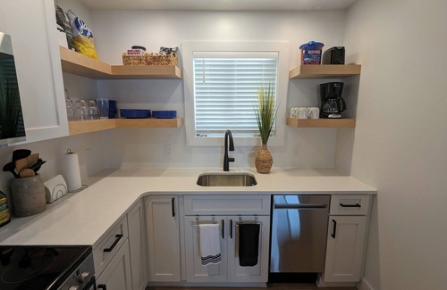 Carp Lake Cottage | NEW! Renovated lakeside cottage with a private sandy beach. Great Location!