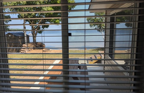Carp Lake Cottage | NEW! Renovated lakeside cottage with a private sandy beach. Great Location!