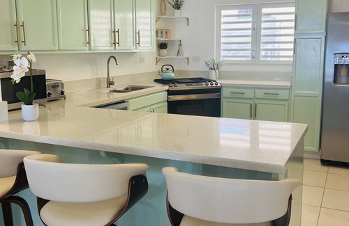 West End Village House | Newly Renovated Luxury West End Home Steps to Mead’s Bay and the Four Seasons.