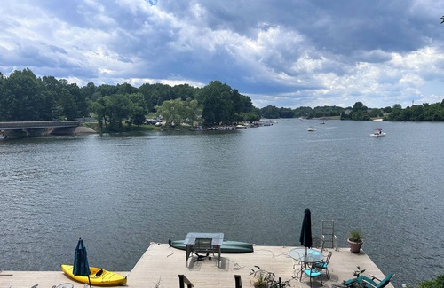 Livingston House | "No Wake Zone" with large dock, covered slip, and diving platform.