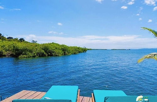 Isla Solarte House | Ocean Light Over Water Bungalow, Bedroom, King Bed, Living Room, Kitchenette