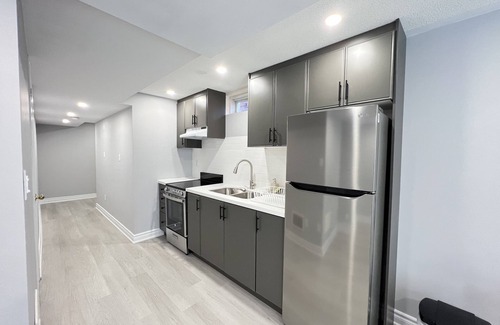 Meadowvale Village House | One bedroom ensuite toilet on main level & kitchen, living, bathroom lower level
